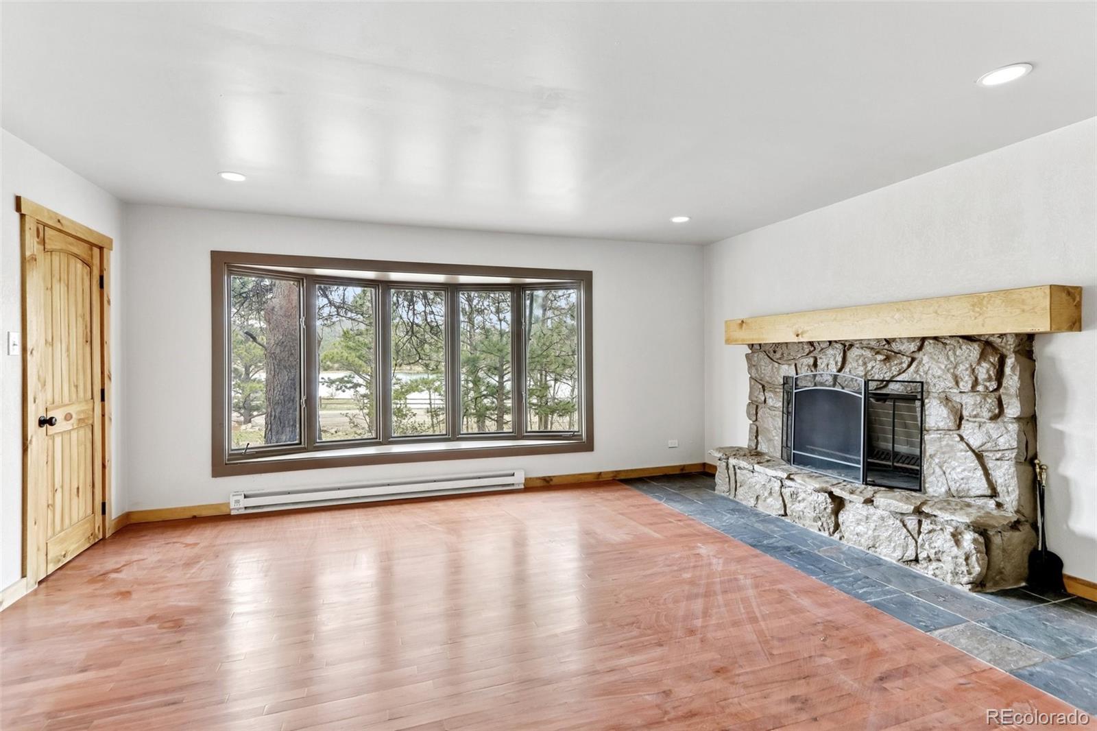61 Evergreen Road Black Hawk, CO 80422 - Photo 33 of 50 a view of an empty room with a fireplace and a window
