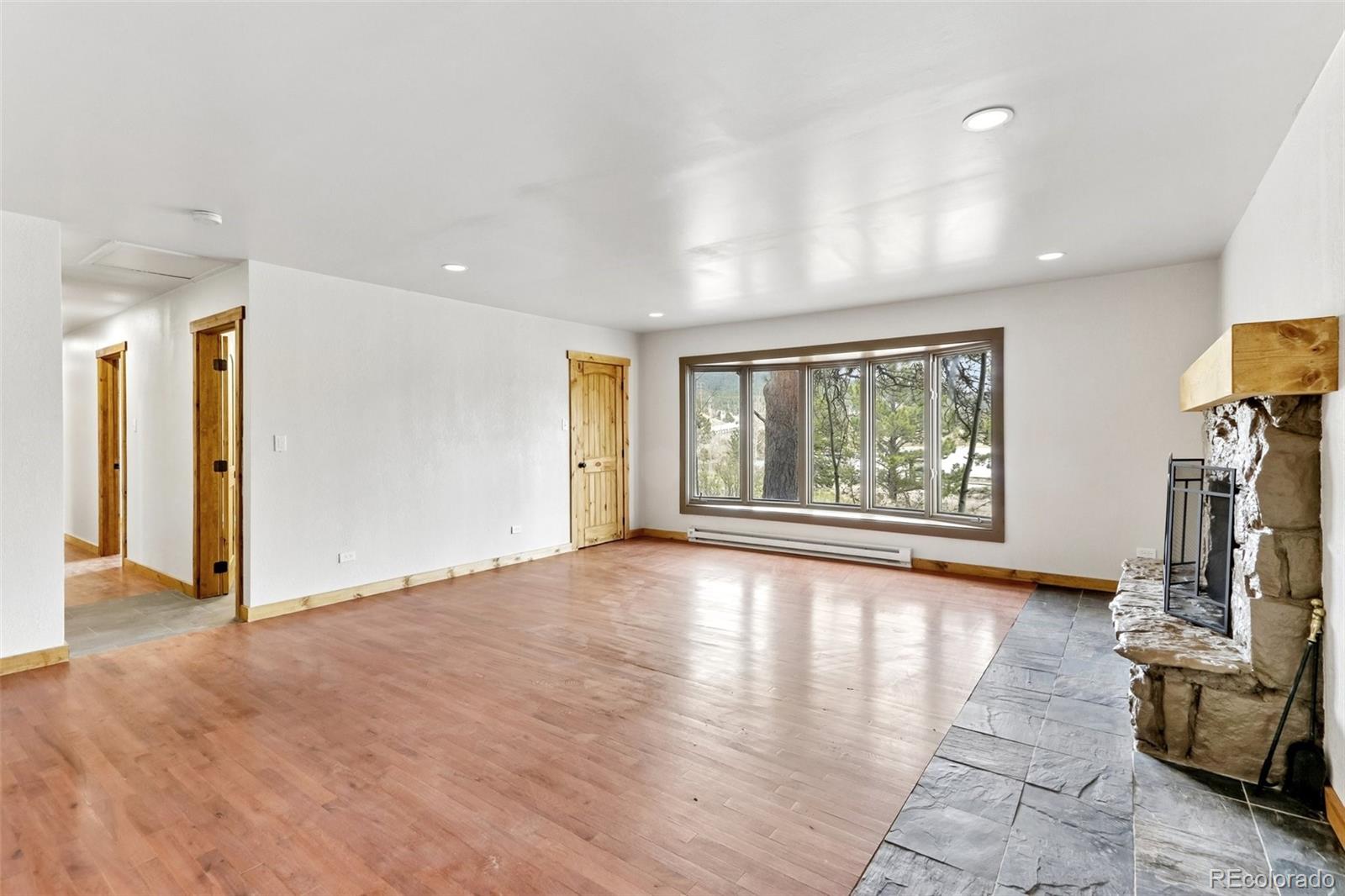 61 Evergreen Road Black Hawk, CO 80422 - Photo 35 of 50 a view of an empty room with a window and wooden floor