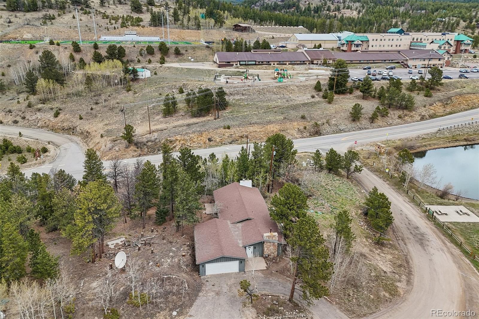 61 Evergreen Road Black Hawk, CO 80422 - Photo 4 of 50 a view of a lake with a yard and mountain