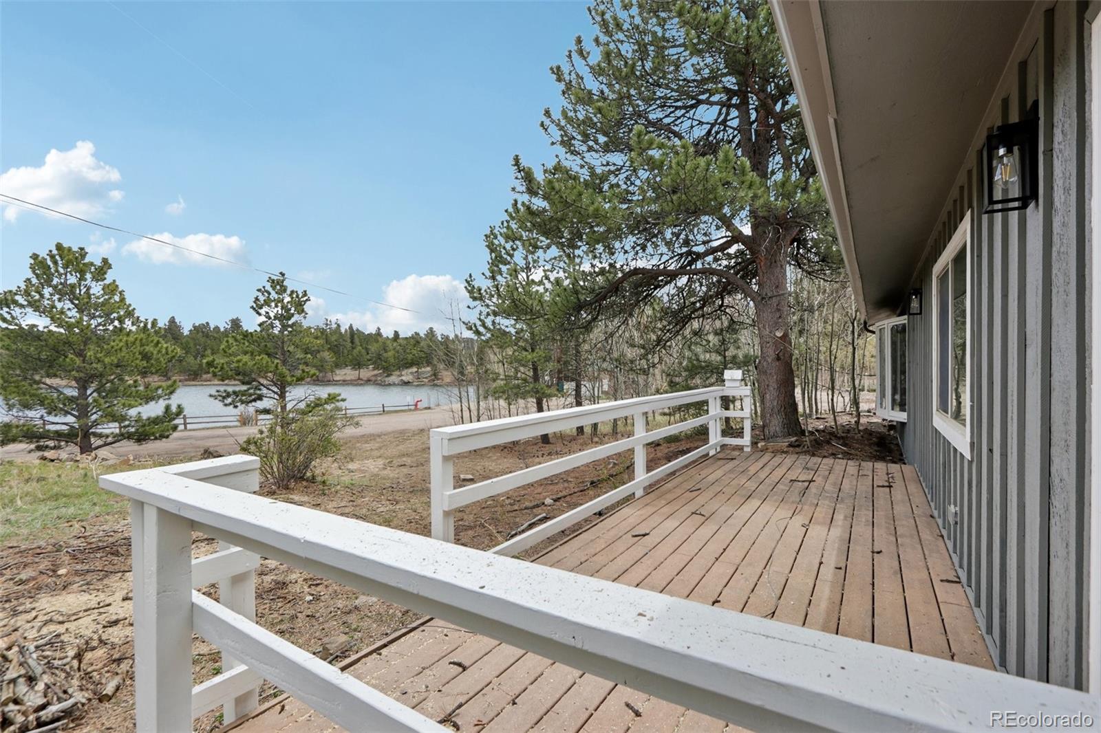 61 Evergreen Road Black Hawk, CO 80422 - Photo 7 of 50 a view of a balcony with wooden floor and fence