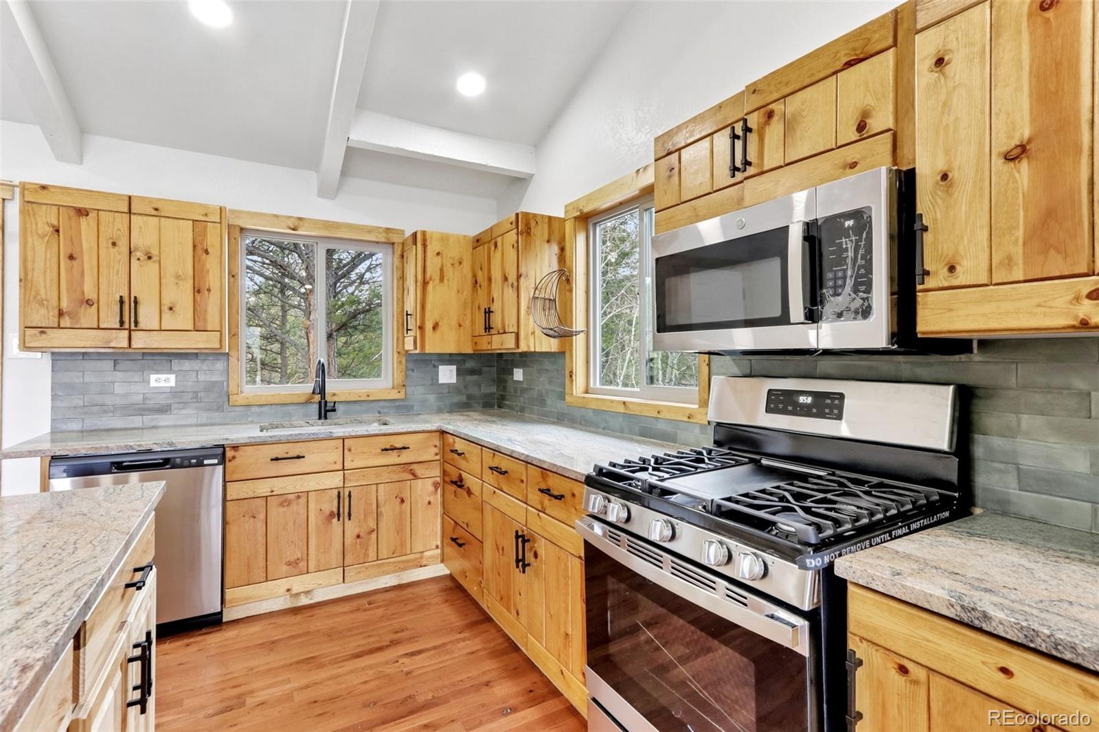 61 Evergreen Road Black Hawk, CO 80422 - Photo 10 of 50 a kitchen with stainless steel appliances granite countertop a stove and a microwave