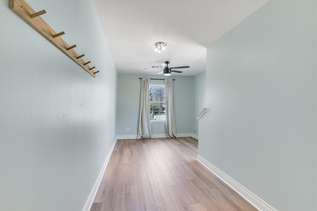 5405 Manor Road Austin, TX 78723 - Photo 13 of 30 Unfurnished room featuring ceiling fan and light wood-style floors