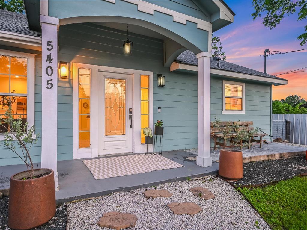 5405 Manor Road Austin, TX 78723 - Photo 16 of 30 Exterior entry at dusk with roof with shingles and covered porch