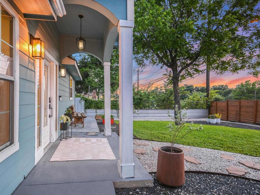 5405 Manor Road Austin, TX 78723 - Photo 17 of 30 Patio terrace at dusk featuring covered porch and a fenced backyard