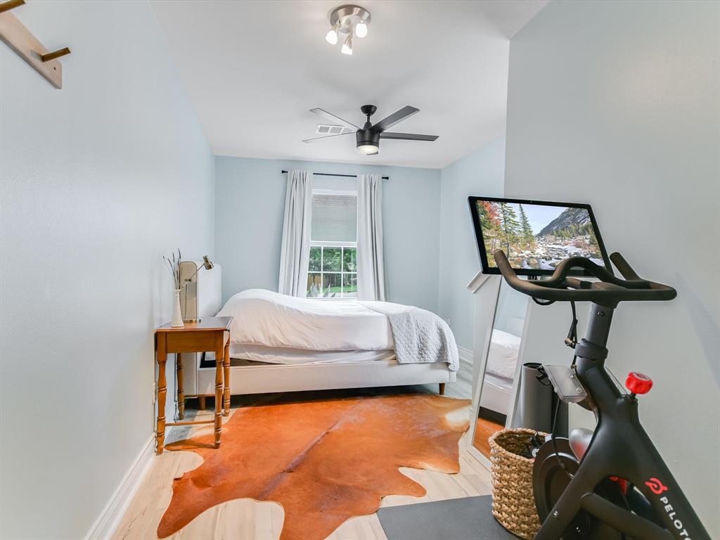 5405 Manor Road Austin, TX 78723 - Photo 19 of 30 Bedroom with light wood-style flooring and a ceiling fan