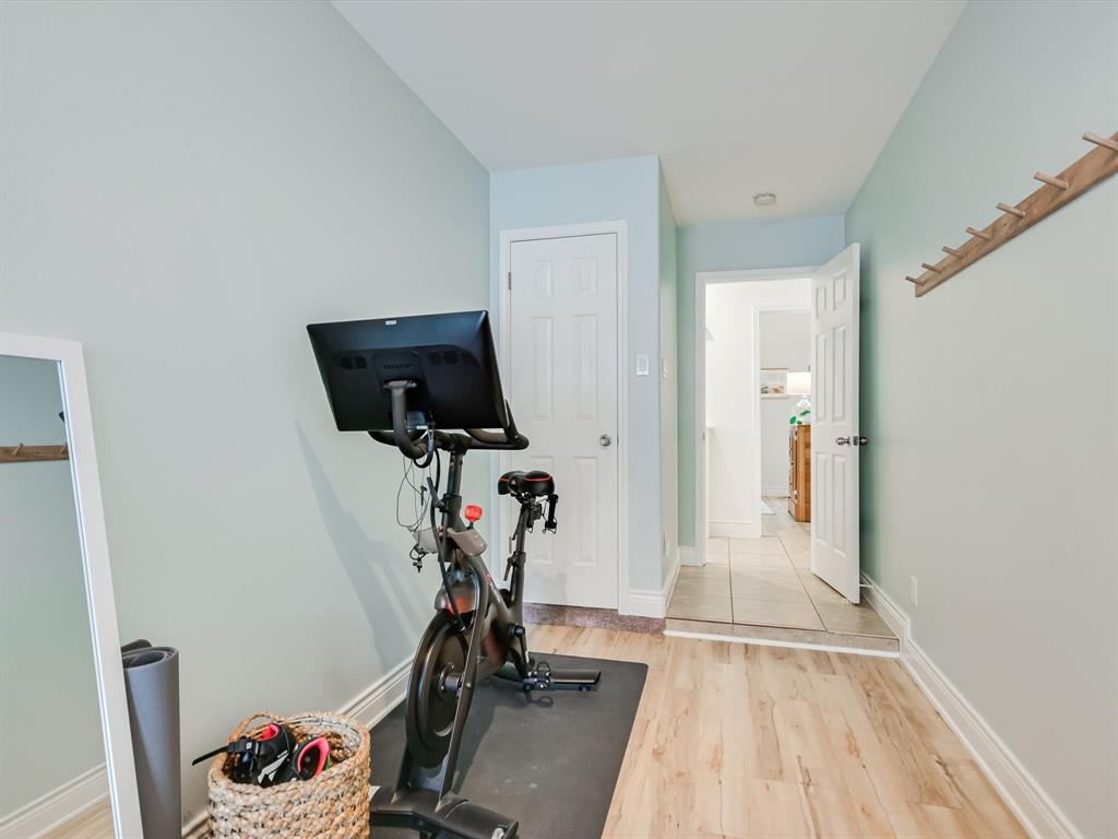 5405 Manor Road Austin, TX 78723 - Photo 20 of 30 Workout area with light wood-style flooring and baseboards