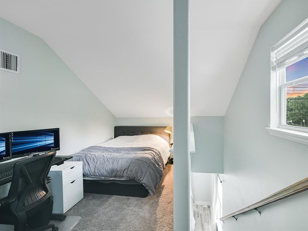 5405 Manor Road Austin, TX 78723 - Photo 24 of 30 Bedroom with vaulted ceiling, carpet, and a desk