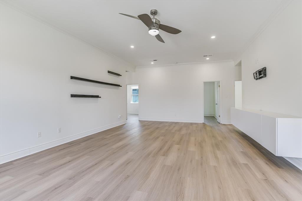 5405 Manor Road Austin, TX 78723 - Photo 5 of 30 Unfurnished room with a ceiling fan, light wood finished floors, recessed lighting, and crown molding