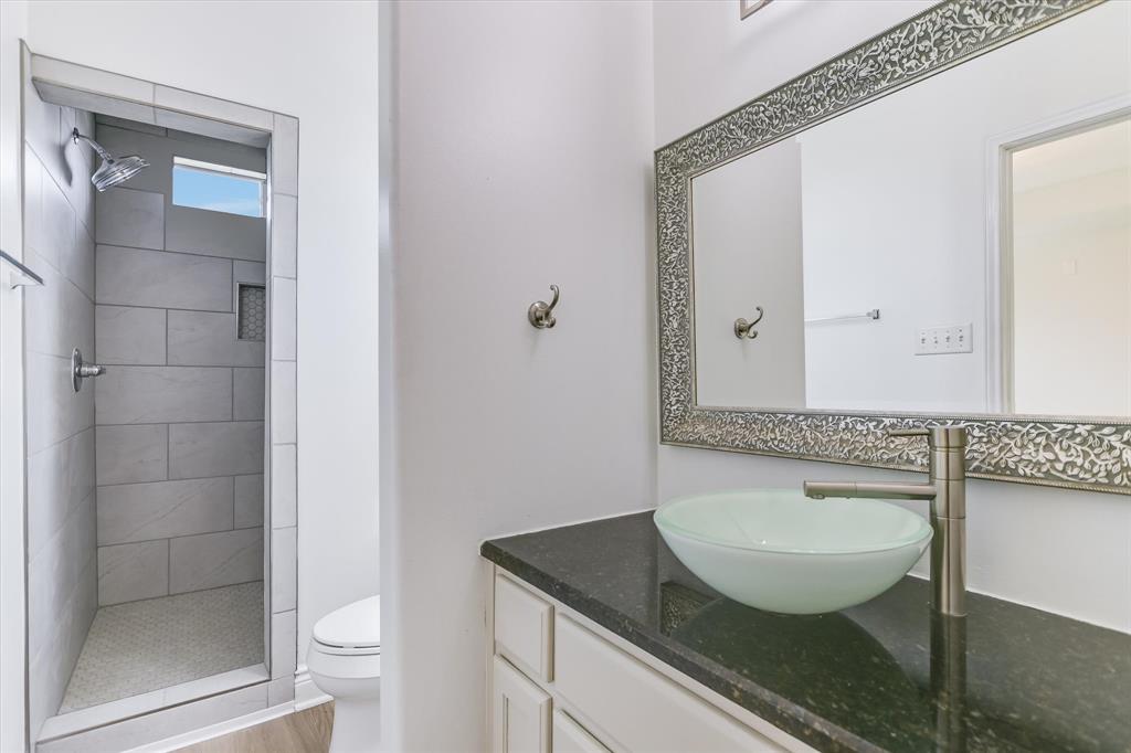 5405 Manor Road Austin, TX 78723 - Photo 9 of 30 Bathroom with vanity and a stall shower