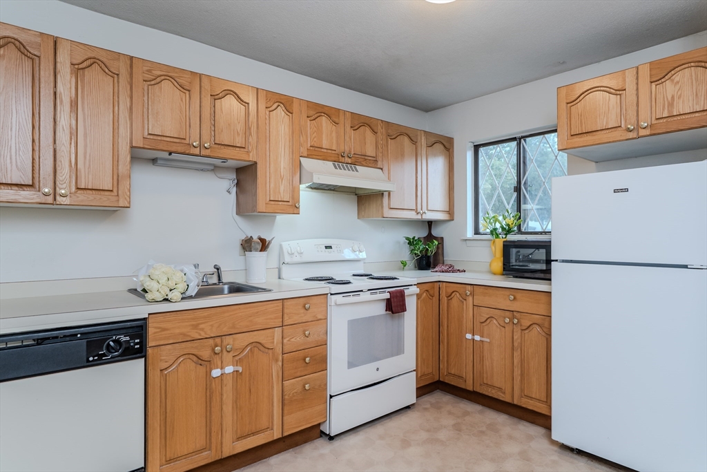 170 East Hadley Road, Unit 123 Amherst, MA 01002 - Photo 11 of 23 a kitchen with stainless steel appliances granite countertop a refrigerator sink and cabinets