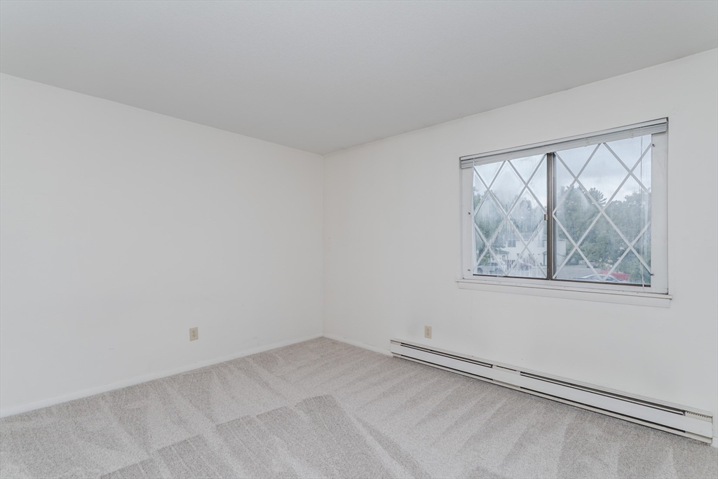 170 East Hadley Road, Unit 123 Amherst, MA 01002 - Photo 20 of 23 an empty room with a window