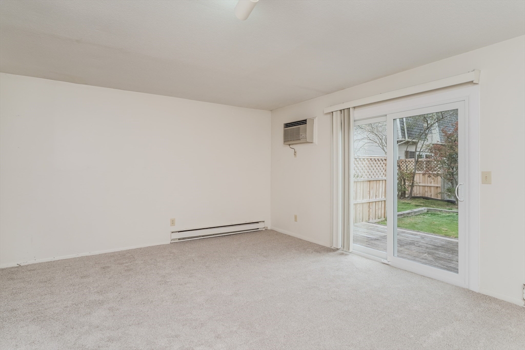 170 East Hadley Road, Unit 123 Amherst, MA 01002 - Photo 8 of 23 an empty room with glass door