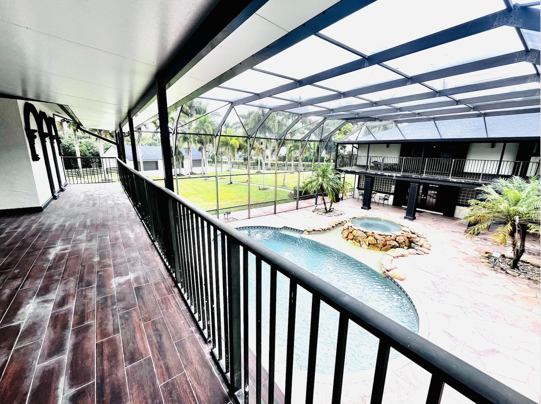 a view of a swimming pool with furniture
