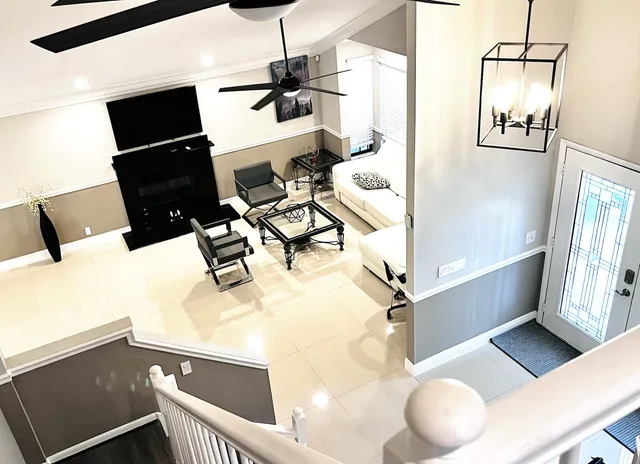 a living room with furniture a flat screen tv and a fireplace