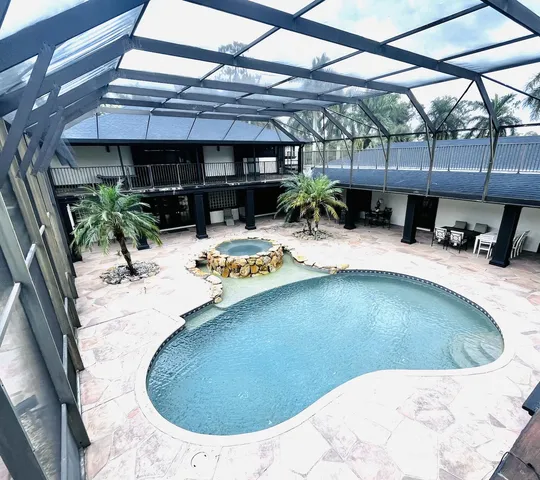 a living room with furniture and a mirror