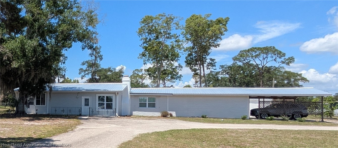 2701 Brunns Road Sebring, FL 33872 - Photo 1 of 29 a front view of a house with a yard and garage