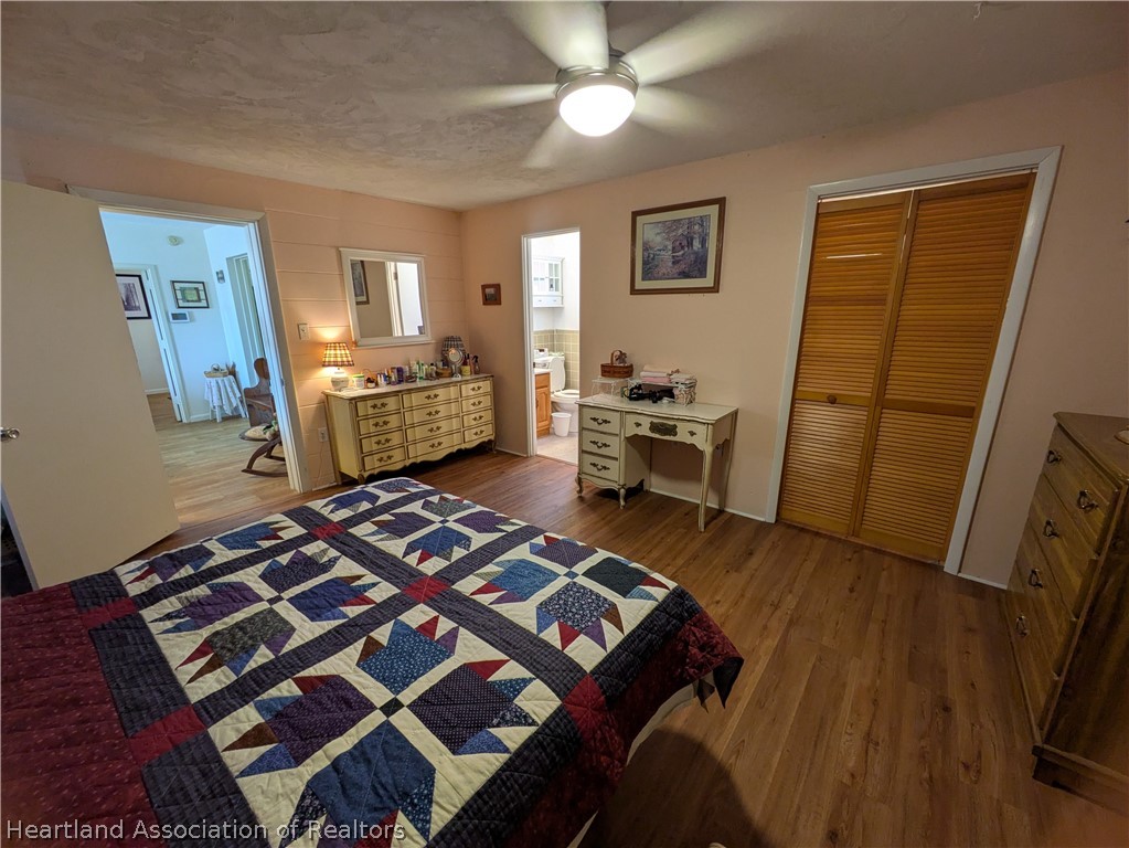 2701 Brunns Road Sebring, FL 33872 - Photo 11 of 29 a bedroom with a bed and wooden floor