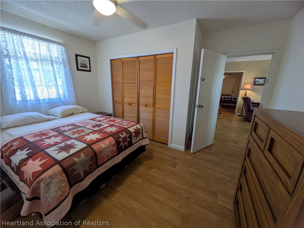 2701 Brunns Road Sebring, FL 33872 - Photo 15 of 29 a bedroom with a bed and a chandelier