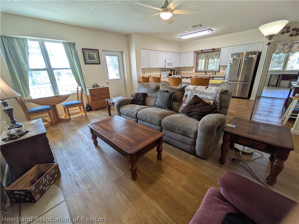 2701 Brunns Road Sebring, FL 33872 - Photo 6 of 29 a living room with furniture a fireplace and a window
