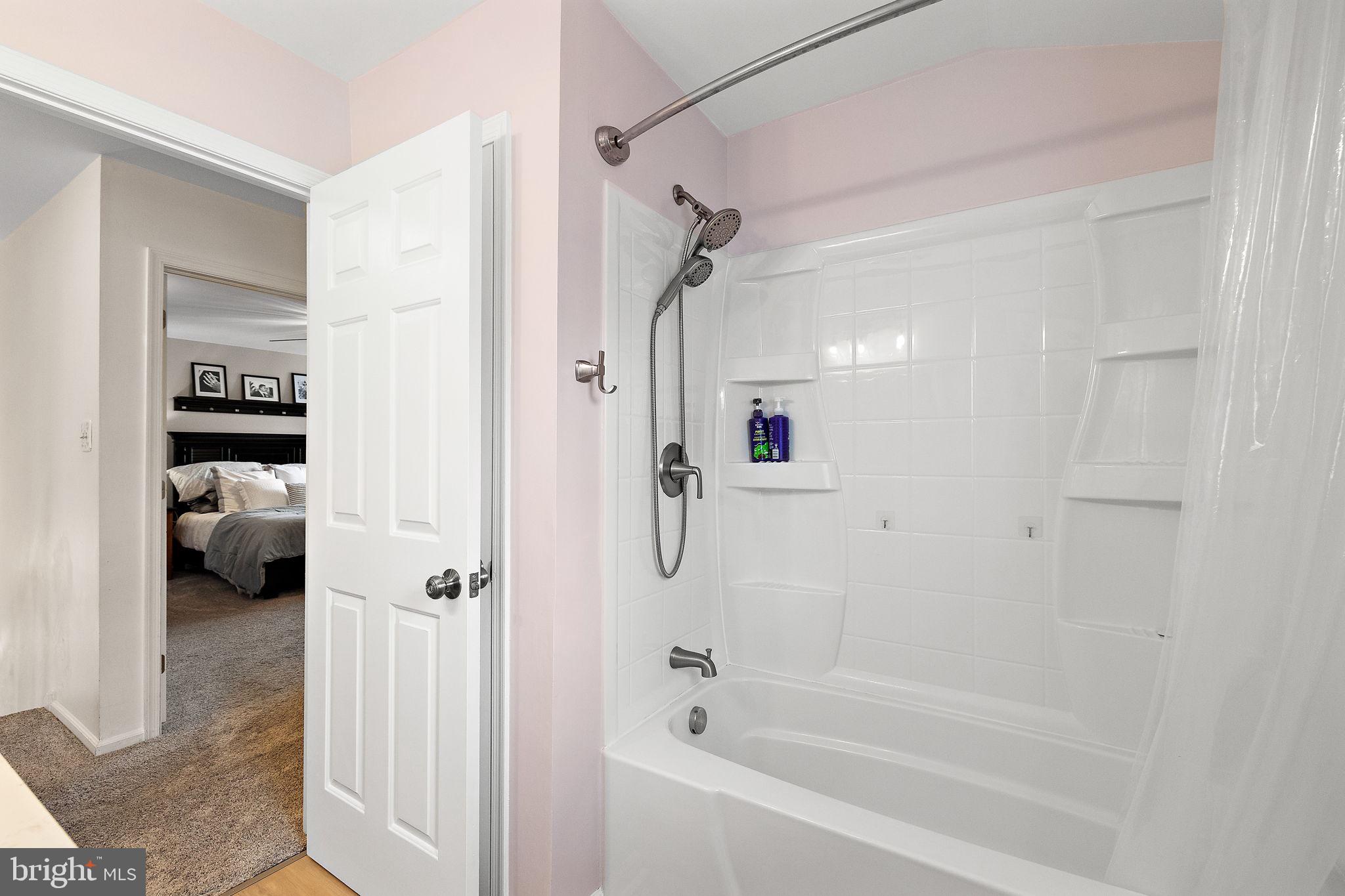1003 White Birch Drive Newark, DE 19713 - Photo 30 of 54 a bathroom with a tub shower vanity and a sink