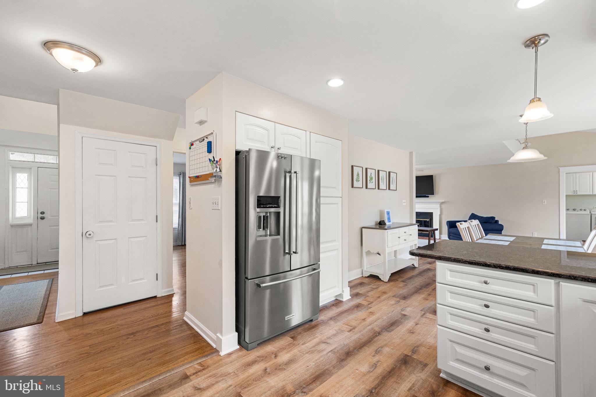 1003 White Birch Drive Newark, DE 19713 - Photo 4 of 54 a kitchen with stainless steel appliances a refrigerator and wooden floor