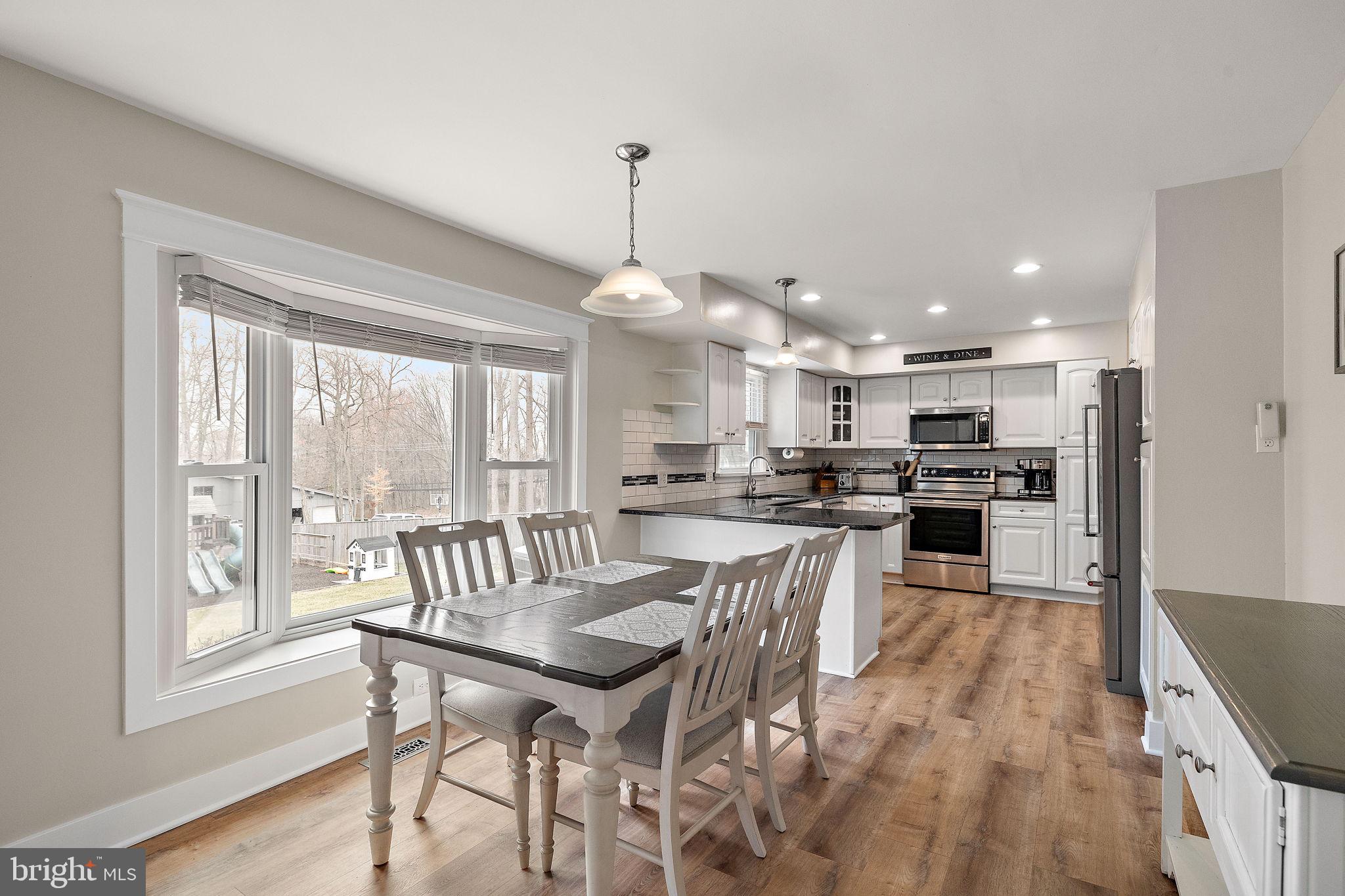 1003 White Birch Drive Newark, DE 19713 - Photo 5 of 54 a view of a dining room and livingroom with furniture wooden floor a chandelier