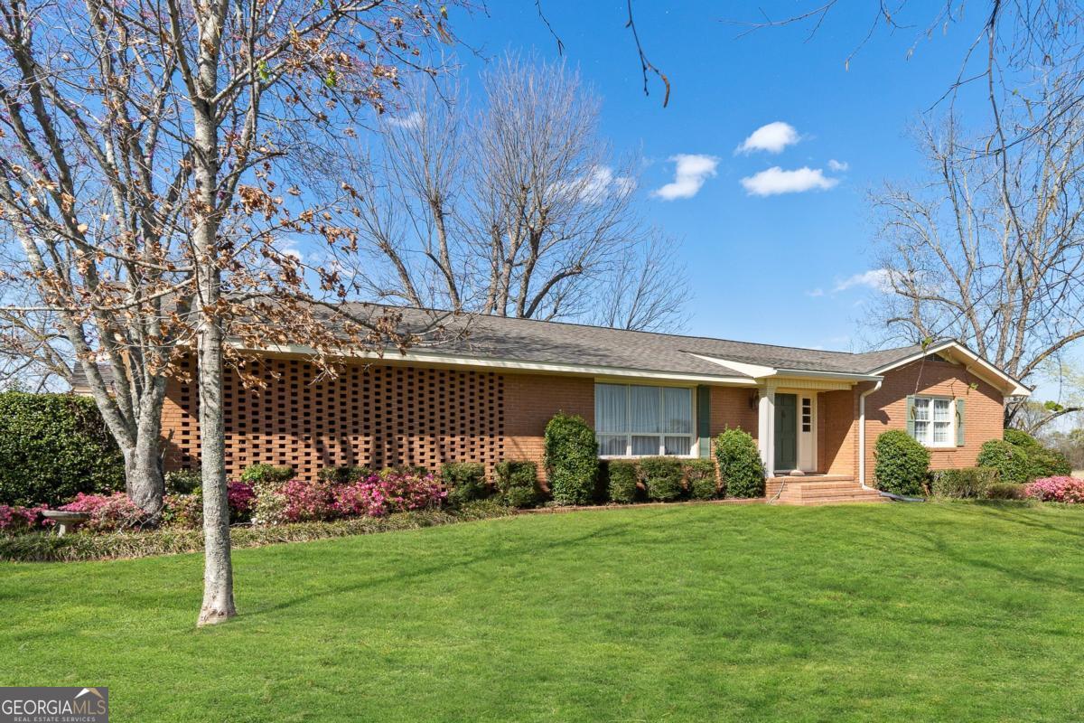 56 Claymont Road McIntyre, GA 31054 - Photo 12 of 75 a front view of a house with garden