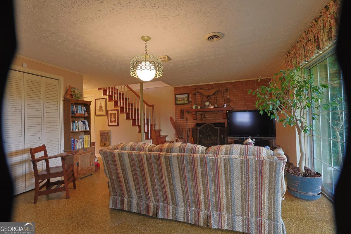 56 Claymont Road McIntyre, GA 31054 - Photo 16 of 75 a living room with furniture and a chandelier
