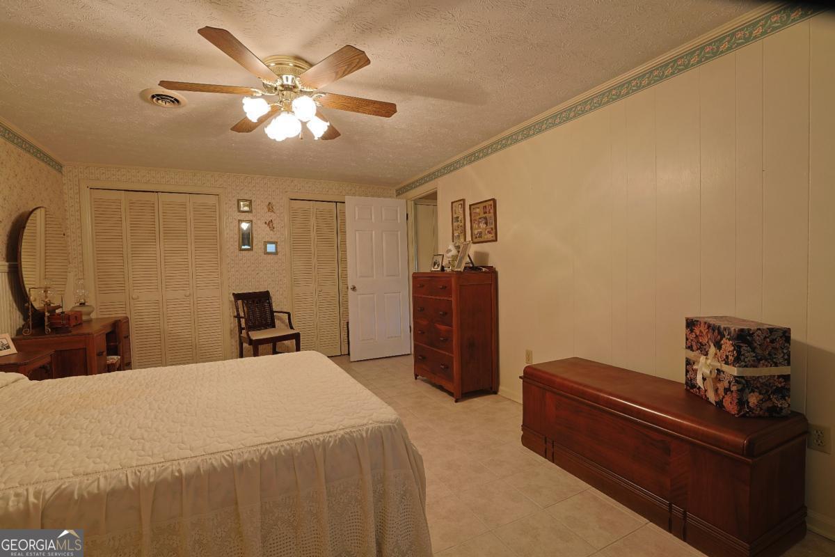 56 Claymont Road McIntyre, GA 31054 - Photo 23 of 75 a bed room with a bed and a chandelier