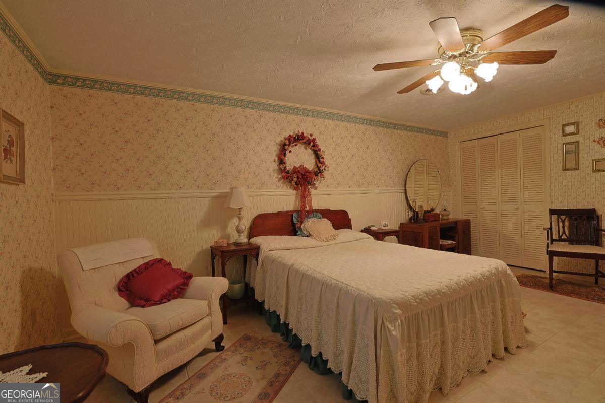 56 Claymont Road McIntyre, GA 31054 - Photo 24 of 75 a bedroom with bed and a chandelier