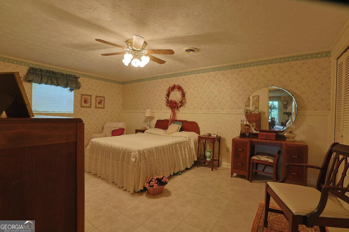 56 Claymont Road McIntyre, GA 31054 - Photo 26 of 75 a bedroom with a bed and a chandelier