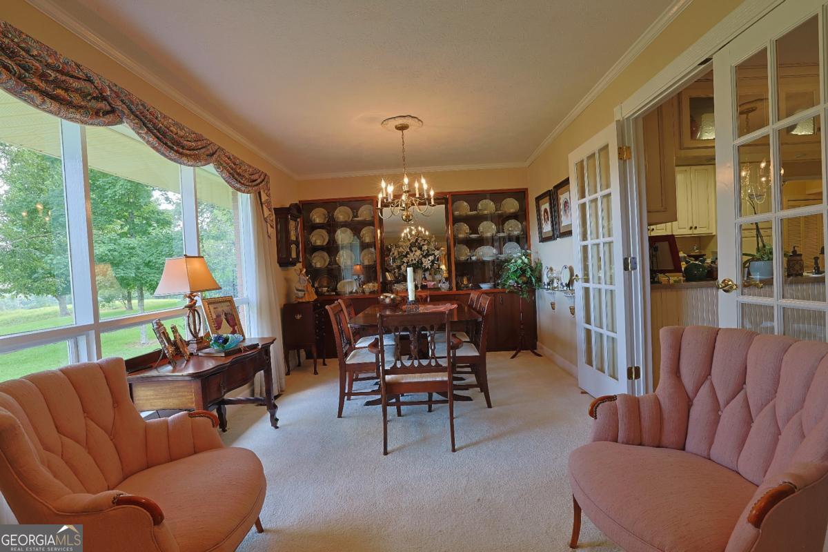 56 Claymont Road McIntyre, GA 31054 - Photo 28 of 75 a living room with furniture a fireplace and a floor to ceiling window