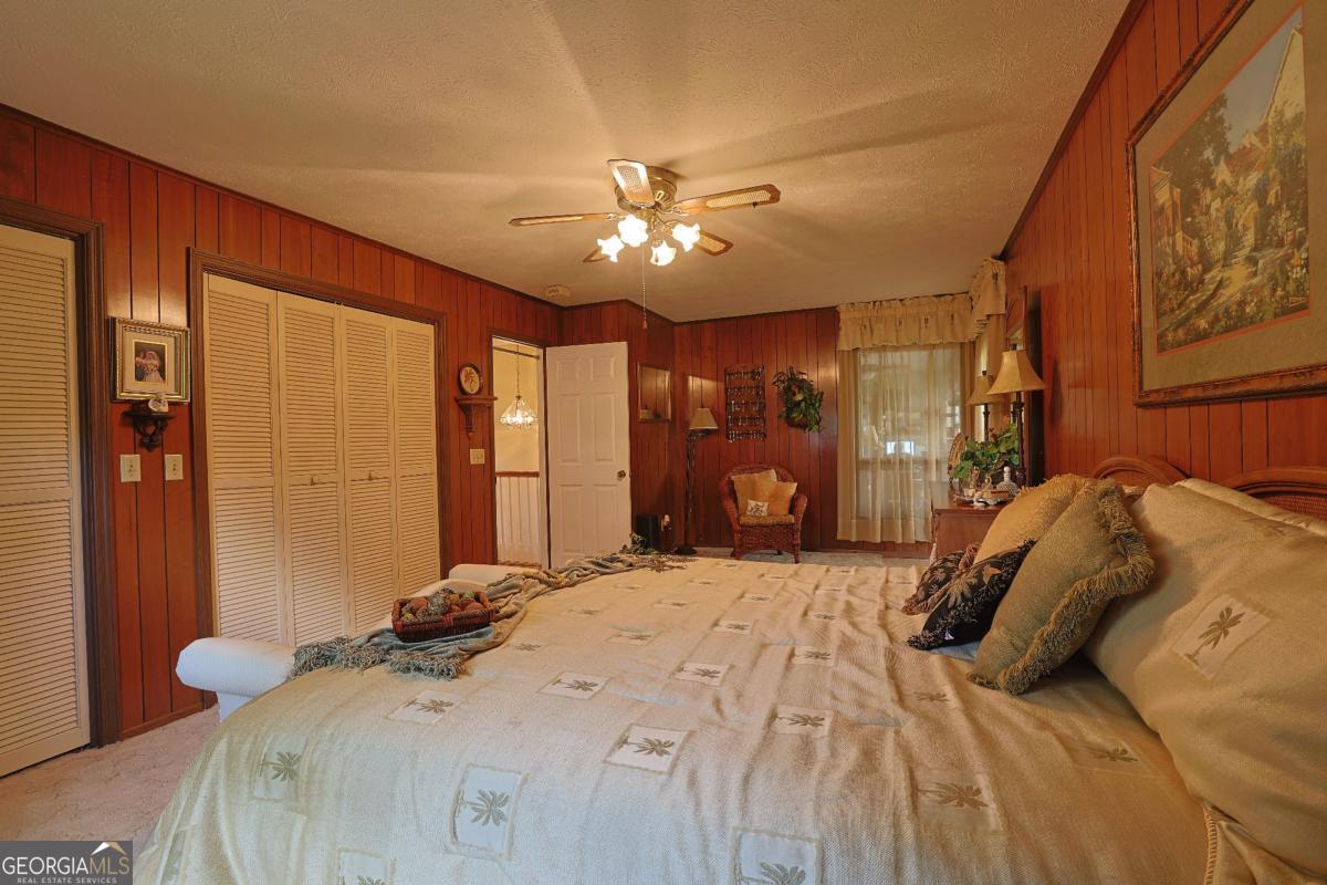 56 Claymont Road McIntyre, GA 31054 - Photo 36 of 75 a bedroom with a bed and a chandelier