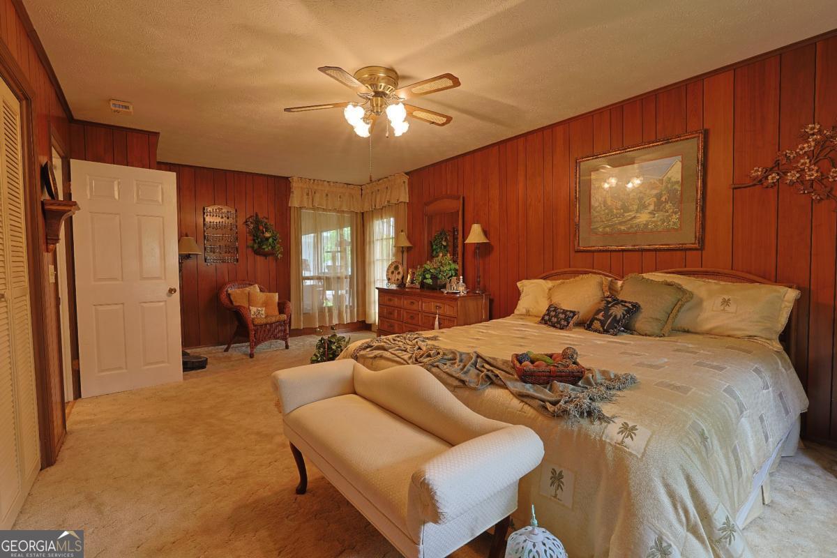 56 Claymont Road McIntyre, GA 31054 - Photo 38 of 75 a bedroom with a bed and ceiling fan