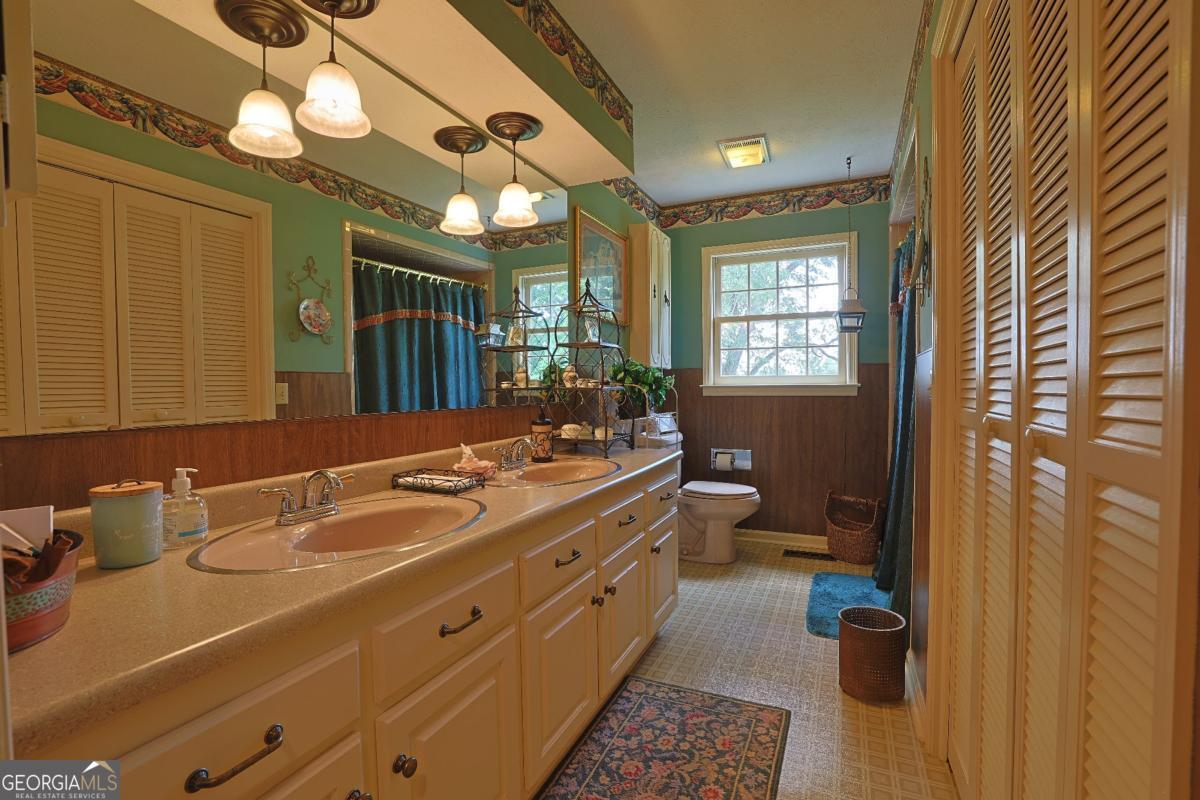 56 Claymont Road McIntyre, GA 31054 - Photo 40 of 75 a spacious bathroom with a double vanity sink a mirror and a shower