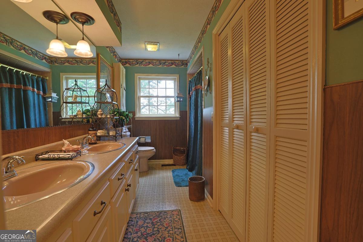 56 Claymont Road McIntyre, GA 31054 - Photo 41 of 75 a bathroom with a sink a toilet a mirror and shower