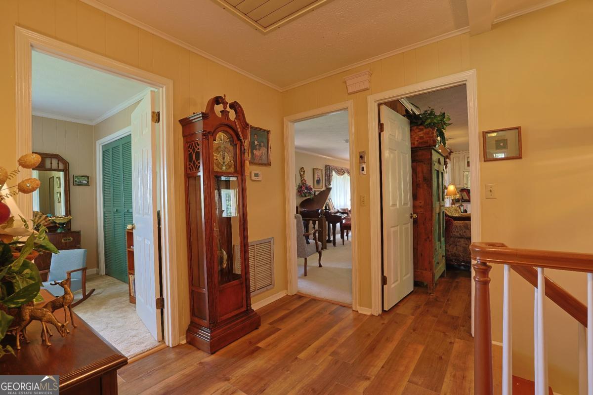 56 Claymont Road McIntyre, GA 31054 - Photo 43 of 75 a view of a hallway with wooden floor and closet