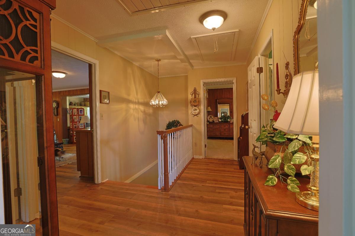 56 Claymont Road McIntyre, GA 31054 - Photo 52 of 75 a view of a hallway with wooden floor and staircase