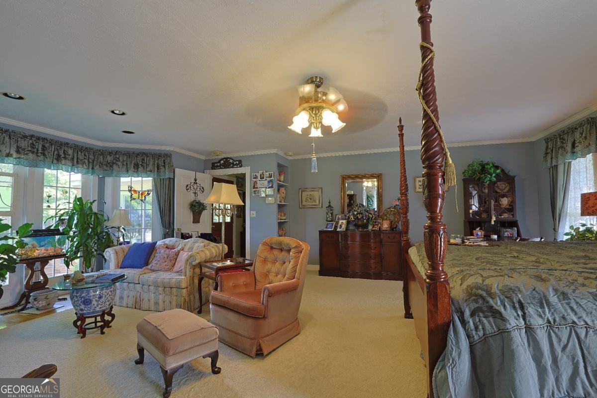56 Claymont Road McIntyre, GA 31054 - Photo 60 of 75 a living room with furniture and a chandelier