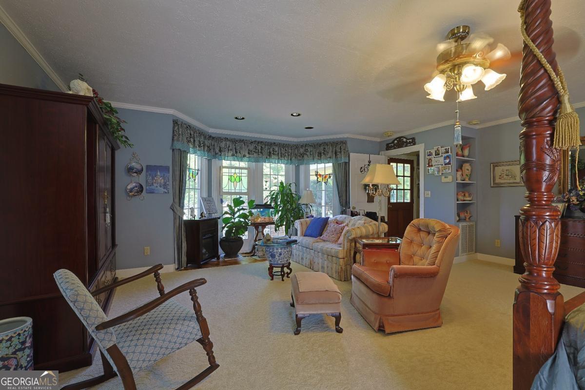 56 Claymont Road McIntyre, GA 31054 - Photo 63 of 75 a living room with furniture a lamp and a chandelier