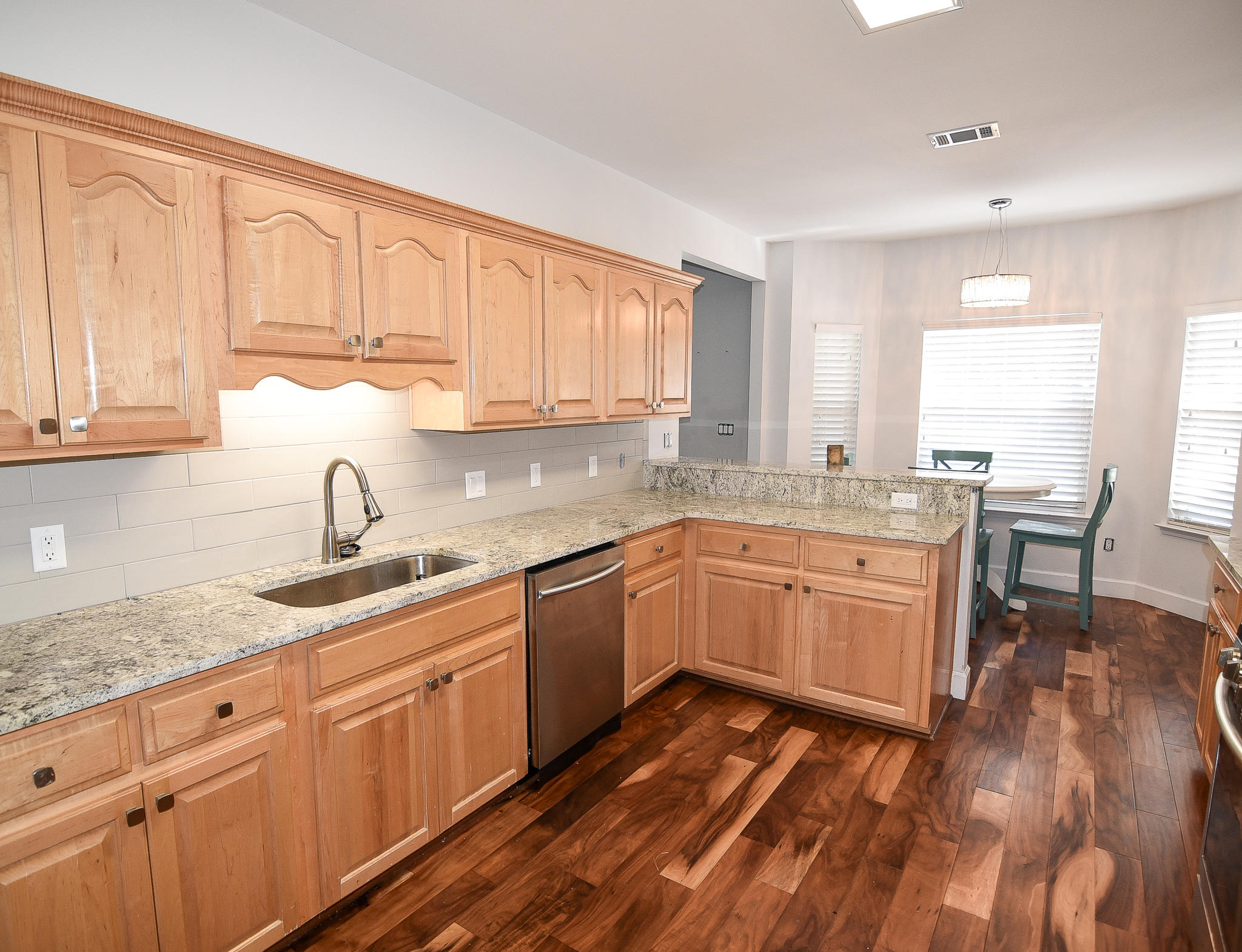 1815 Huntington Road Niceville, FL 32578 - Photo 21 of 51 a kitchen with granite countertop wooden cabinets a sink and dishwasher with wooden floor