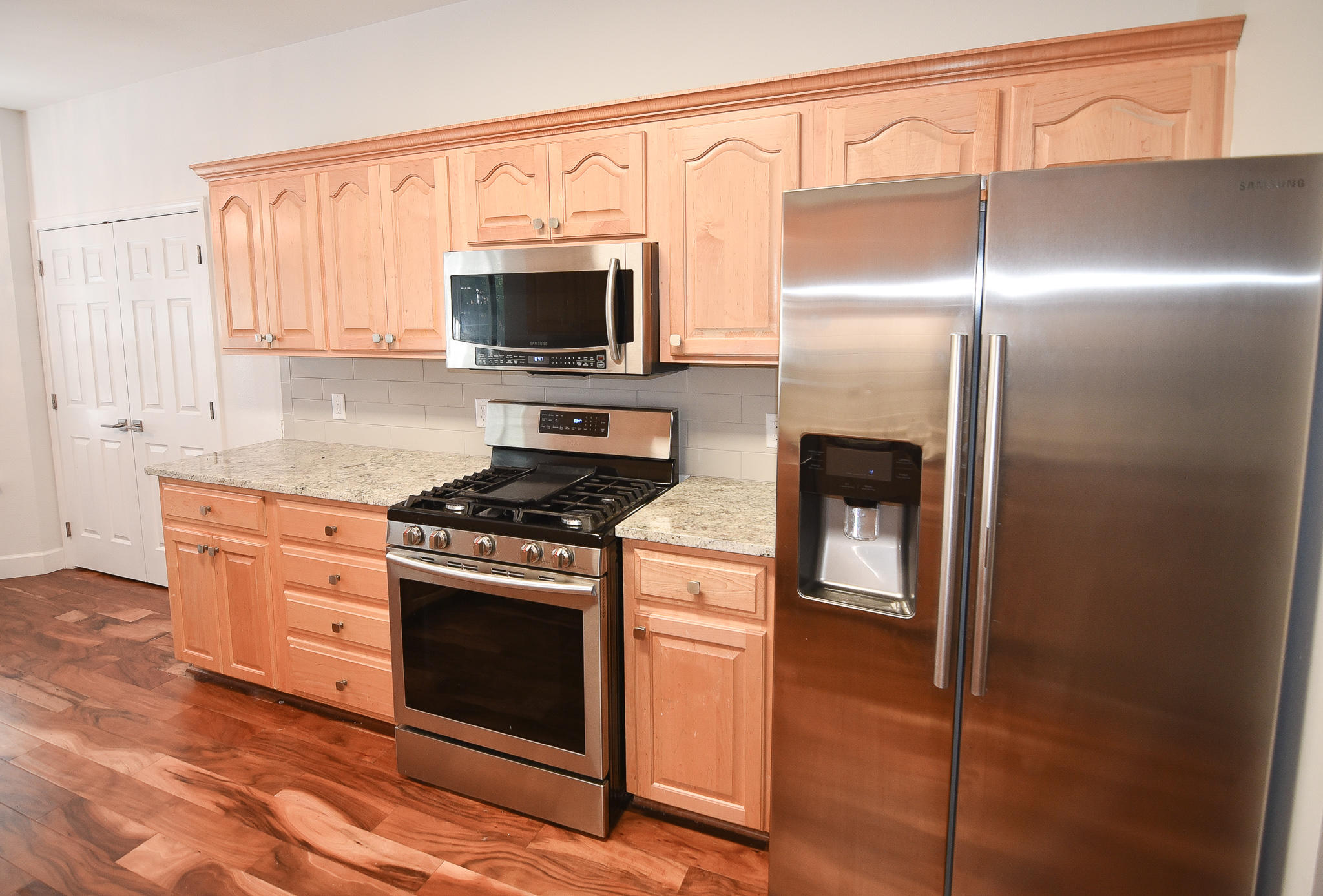 1815 Huntington Road Niceville, FL 32578 - Photo 22 of 51 a kitchen with stainless steel appliances granite countertop a stove a microwave and a refrigerator