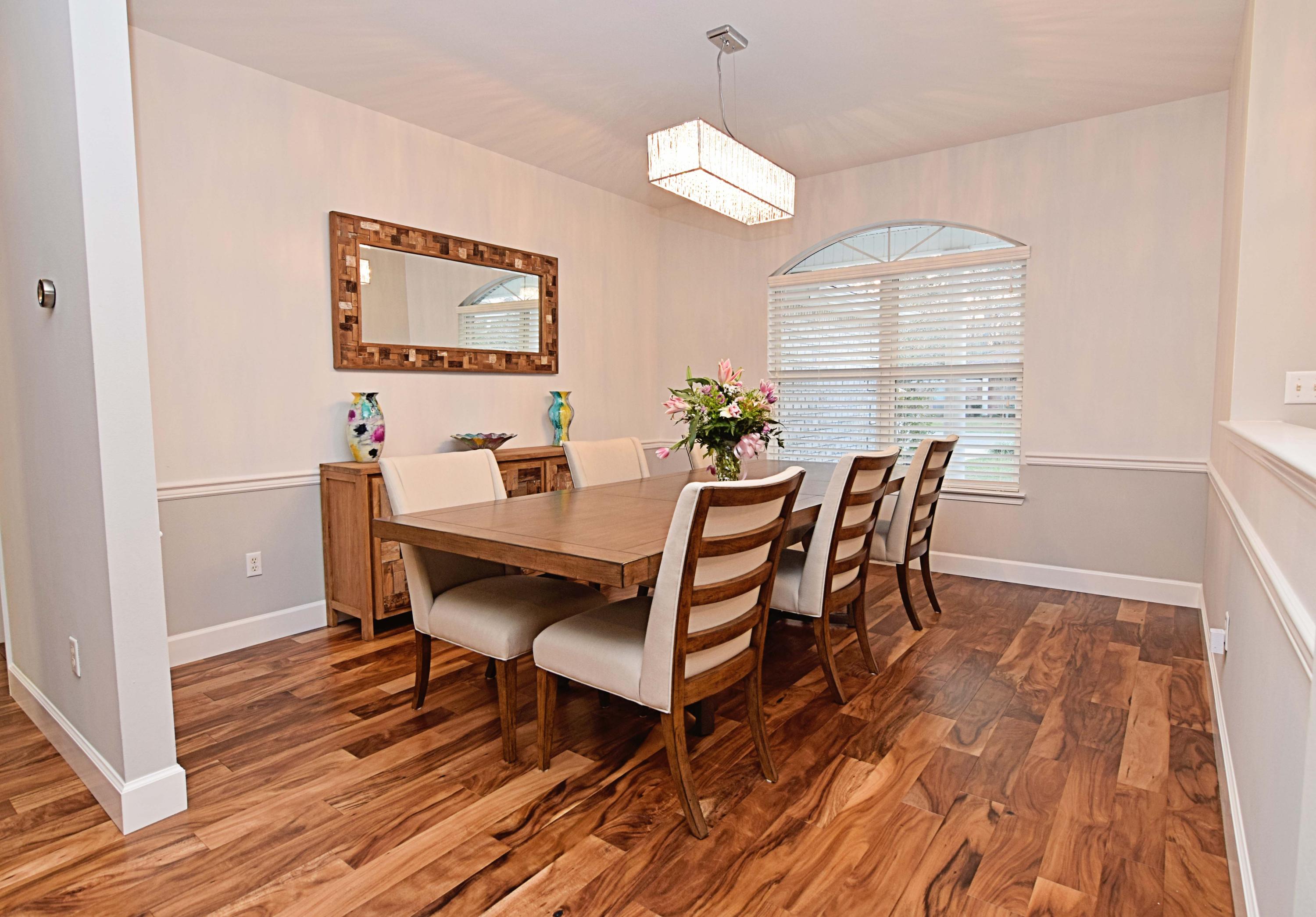1815 Huntington Road Niceville, FL 32578 - Photo 6 of 51 a view of a dining room with furniture a chandelier and wooden floor