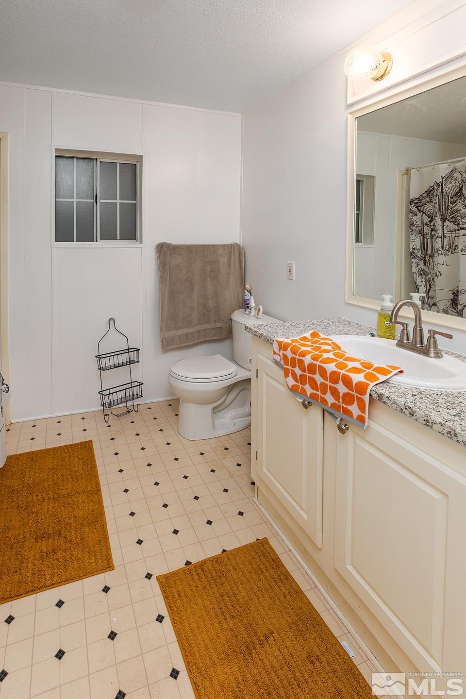 5215 Workman Road Fallon, NV 89406 - Photo 12 of 21 a bathroom with a sink toilet and shower