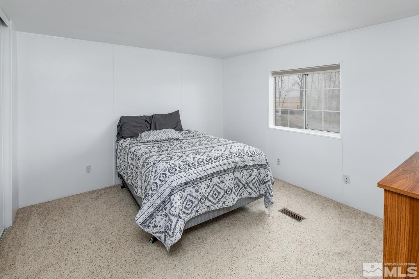 5215 Workman Road Fallon, NV 89406 - Photo 16 of 21 a bedroom with a bed and a window