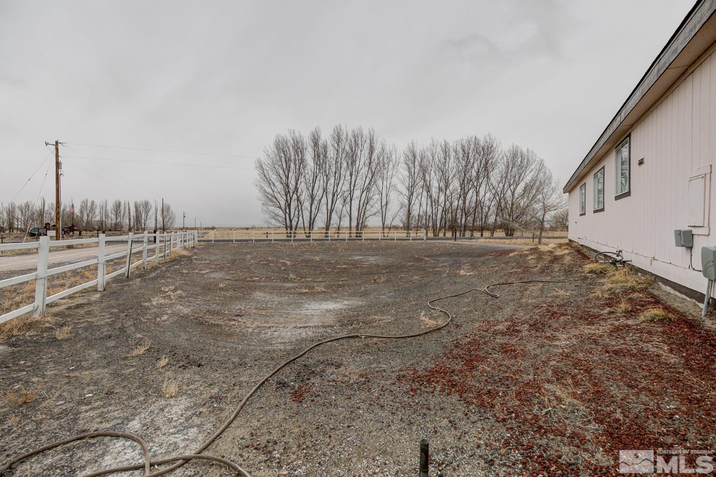 5215 Workman Road Fallon, NV 89406 - Photo 20 of 21 a view of a yard with trees in the background