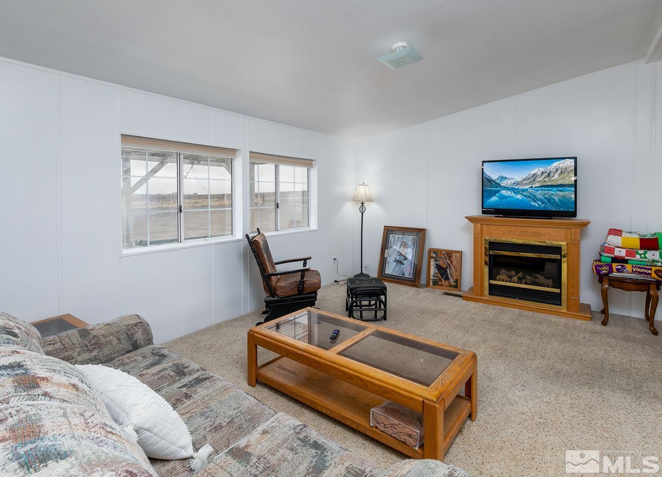 5215 Workman Road Fallon, NV 89406 - Photo 4 of 21 a bedroom with furniture and a fireplace