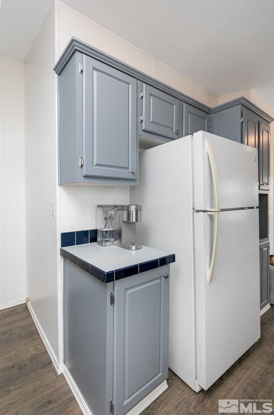 5215 Workman Road Fallon, NV 89406 - Photo 7 of 21 a white kitchen with a sink and a refrigerator
