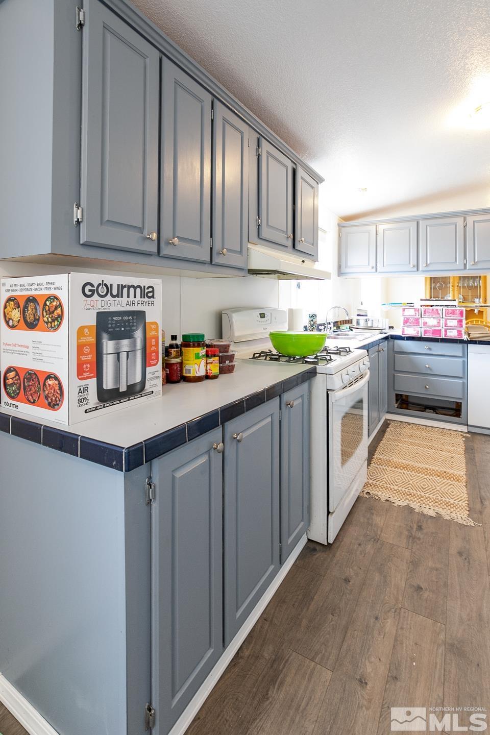 5215 Workman Road Fallon, NV 89406 - Photo 8 of 21 a kitchen with stainless steel appliances granite countertop a sink and cabinets