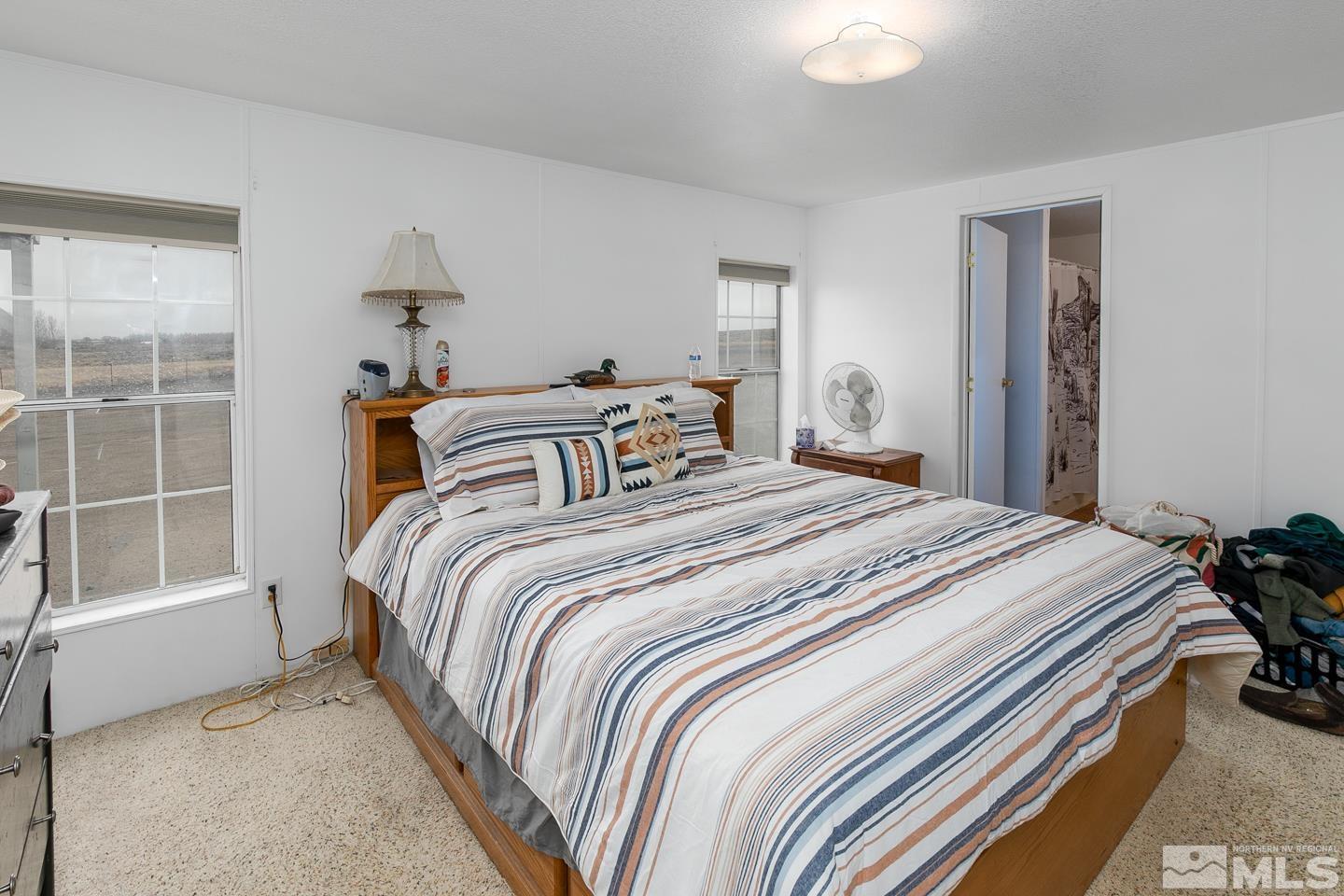 5215 Workman Road Fallon, NV 89406 - Photo 10 of 21 a bedroom with a bed and a window